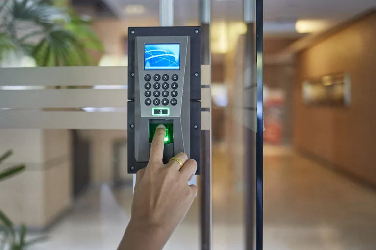 Biometric access-control reader installed on a commercial glass door